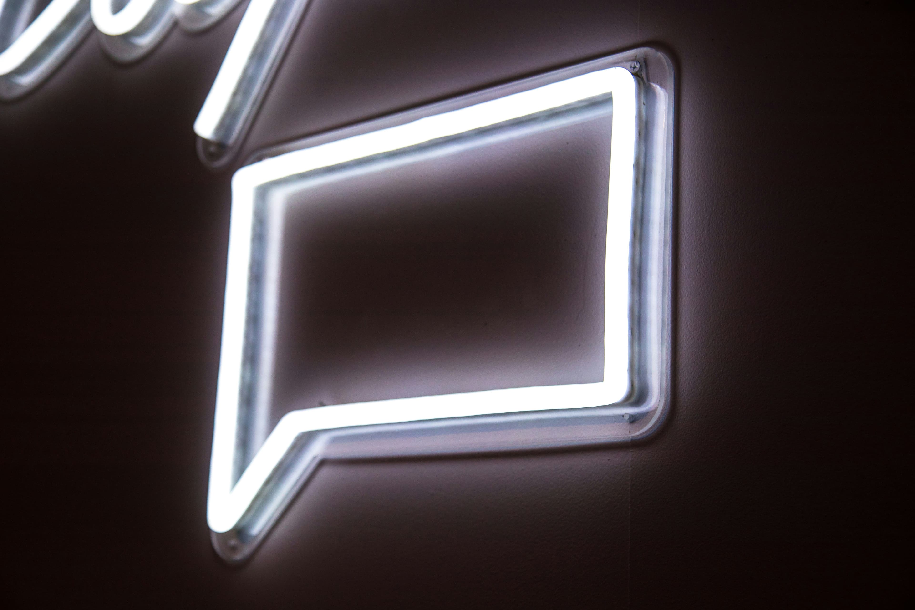 Neon sign with a chat icon